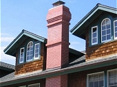 Brick chimney with corbelling courses
