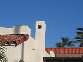 Stucco chimney and ornate chimney cap