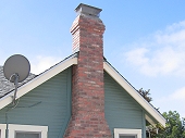 Brick chimney with corbels near top crown