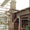 Custom Masonry Brick Chimney with brick corbels just below chimney cap and spark arrestor