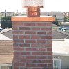 Custom Masonry Brick Chimney with copper chase cover and spark arrestor