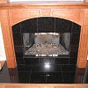 Black Marble Face Firepace and hearth - floor to ceiling custom wood mantel